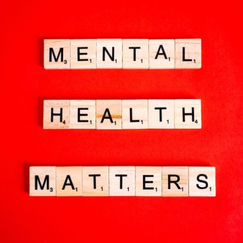 red background with Scrabble tiles spelling out mental health matters