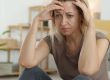 lady holding her head in deep worry