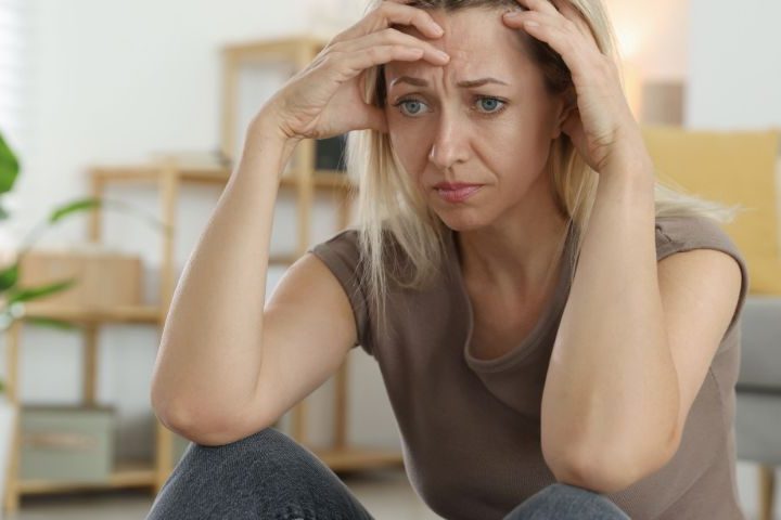lady holding her head in deep worry