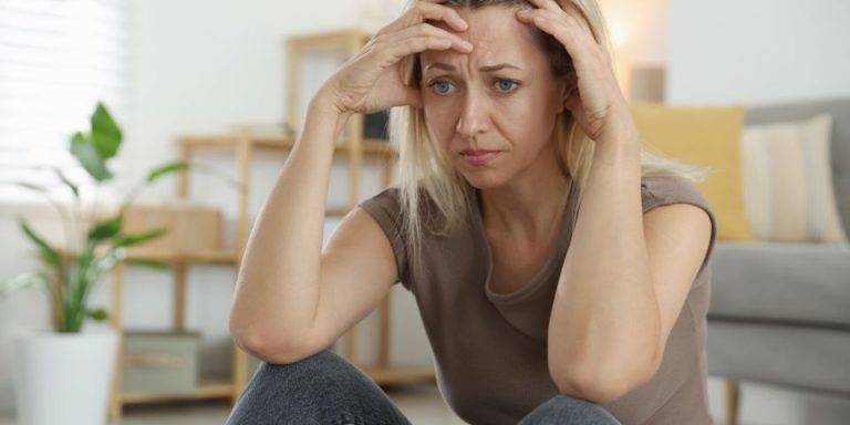 lady holding her head in deep worry